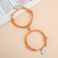 Handmade woven magnetic attraction couple bracelet featuring a cute smiley face charm. - One Pair / Orange