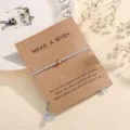 Simple braided cotton rope wish bracelet with gold tone metal bead and kraft paper card. - Multicolor (F12)