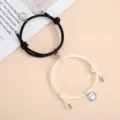 Magnetic couple braided bracelets set with cute smiley face pendants for matching wear details. - One Pair / Off-White And Black