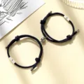 Close-up details of magnetic couple bracelets featuring sun and moon charms on black braided rope. - Milan Cord Sun Moon Dark Blue Pair