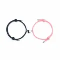 Detailed shot of couple magnetic braided bracelets with black and pink matching heart pendants. - Black And Pink Pair