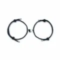 Detailed view of black woven rope couple bracelets featuring a connected magnetic heart charm. - Black Pair