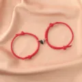 Close-up detail of stylish black and white magnetic heart couple rope bracelets set. - Red Pair / Red