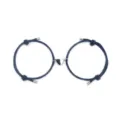 Close-up detail of magnetic couple bracelet with dark blue braided cord and heart charm. - Dark Blue Pair