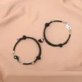 Black and white magnetic couple bracelets featuring cute yin yang design and braided rope details. - Tai Chi Black White Magnet Black Pair