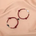Magnetic couple bracelets set with matching red rope and black white yin yang heart charm. - Tai Chi Black White Magnet Wine Red Pair