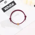 Minimalist burgundy rope bracelet with metallic tips and a golden gear bead for daily wear. - Gold Tungsten Carbide Bracelet (Metal End) / Burgundy