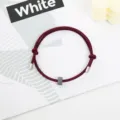 Burgundy rope bracelet with metal tips and tungsten bead, minimalist survival accessory detail view. - Tungsten Carbide Bracelet (Metal End) / Burgundy