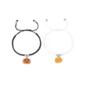 Close-up details of the handmade woven couple bracelet with a cute pumpkin charm. - Flat Knot Black and White Style D