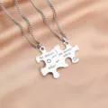 Stainless steel couple puzzle necklace set featuring engraved love pendant details. - Stainless Steel Chain Pair / Puzzle Necklace Model A (No matter what/where)