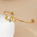 Bracelet en acier inoxydable doré avec pendentif cœur amour et détail de cristal. - Style Nœud de Cœur / Or / Pierre de Naissance d'Avril