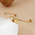 Bracelet jonc ouvert en acier dore avec noeud de coeur et charm love pour femme et cadeau. - Or / Pierre de Naissance de Juillet