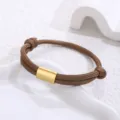 Handmade braided brown paracord bracelet detail featuring a smooth gold stainless steel tube. - Gold Accessory / Brown Paracord