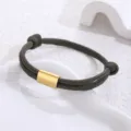 Close-up of the green paracord bracelet featuring a polished gold stainless steel tube detail. - Army Green Paracord
