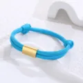 Close-up view of the blue braided paracord bracelet featuring a polished gold stainless steel tube. - Light Blue Paracord