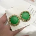 Detailed view of vintage green leather round earrings with gold chain border and S925 silver pin. - Green