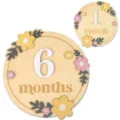 Close-up detail of wooden baby milestone disc featuring floral design and engraved monthly text. - White Number Set / Colorful Floral
