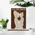 Wooden mom plaque detail showing the engraved mother daughter silhouette and heartfelt message. - Gift From Girl to Mom