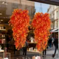 Artificial orange eucalyptus hanging vines, perfect autumn window decoration detail view. - Orange