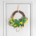 Artificial floral wreath detail shot featuring green leaves and yellow wildflowers for home decor. - Yellow