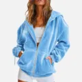 Close-up detail of blue velvet zip-up hoodie texture, soft fabric and smooth zipper. - S / Sky Blue