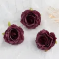 Close-up detail of dark red artificial rose flower heads for DIY crafts and wedding decoration. - Deep purple