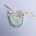 Mini handmade doll apron with green ruffles and ribbon tie, perfect for craft plush toy dress up. - White Bib with Green Lace