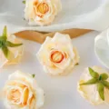 Artificial rolled rose heads, champagne color, ideal for DIY floral decor and craft projects. - Champagne
