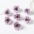 Close-up detail shot of artificial purple rose fabric flower heads for DIY crafts and decor. - Deep purple