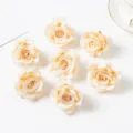 Artificial silk rose heads detail shot, champagne colored floral decorations for DIY crafts. - Champagne