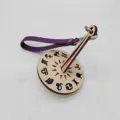 Portable wooden wrist yarn holder with zodiac symbols and purple leather strap for knitting crafts. - Purple Leather Strap