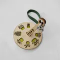 Portable wooden wrist yarn holder with green leather strap and engraved plant patterns. - Green Leather Belt