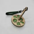 Portable wooden wrist yarn holder with green leather strap for knitting and crafting enthusiasts. - Dark Green Strap