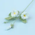 Macro detail of handmade crochet morning glory flower in soft blue yarn - Blue Morning Glory Branch (Meng Si)