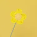 Detailed macro view showing the intricate crochet texture of a handmade yellow yarn flower - Yellow