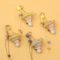 Detailed view of handmade crochet mushroom keychains in soft pastel yellow wool yarn - Yellow