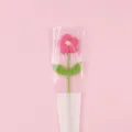 Handcrafted pink crochet puff flower shown inside a 'LOVE' themed gift packaging sleeve - Large Puff Flower (Double Leaf) With Bag / Rose Red