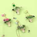 Group display of handmade crochet mushroom keychains with colorful pom-poms and beads - Light Green