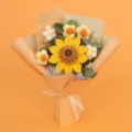 Close-up view of a handmade crochet sunflower and daisy bouquet in elegant orange wrapping - Large Single Layer Seed Sunflower Bouquet (Medium) / Yellow (Yellow Paper)