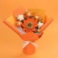 Handmade crochet sunflower bouquet featuring detailed yarn texture and orange wrapping paper - Large Single Layer Seed Sunflower Bouquet (Medium) / Orange