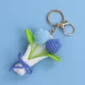 Detailed view of a handmade crocheted blue tulip bouquet keychain with golden clasp. - Double Tulip Bouquet Keychain (Lobster Clasp) / Gradient Blue