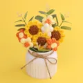 Detailed macro view of a handmade crochet sunflower and puff flower bouquet in a white vase - 3 Little Sun Sunflowers / Flower Series-3 Little Sun Sunflowers (White Pot)