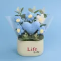 Close-up of handmade crochet blue heart and puff flowers in a cream-colored pot - Single Heart Flower Tube (Life Pot) / Blue