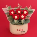 Handmade red and white knitted puff flowers in a cream ceramic pot with Life Life text - Puff Flower Potted Plant / Red