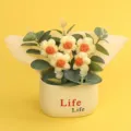 Handmade yellow crochet puff flower arrangement in cream pot on bright yellow background - Puff Flower Potted Plant / Yellow