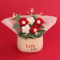 Macro view of handmade crochet red and white puff flowers in a decorative potted gift set - Puff Flower Potted Plant / Gradient Red