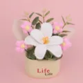 Detailed close-up view of handmade crochet flower bouquet in cream decorative pot - White
