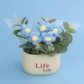 Detailed view of a handmade blue crochet puff flower bouquet in a white pot - Puff Flower Potted Plant / Blue