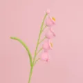 Close-up view of hand-knitted pink Lily of the Valley flowers with soft yarn texture. - Four-Head Lily of the Valley Branch (Finished) / Pink