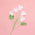 Detail view showing soft texture of handmade crocheted pink and white pansy flowers - Pink